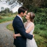 bride wearing a flowy dress and rose gold headband
